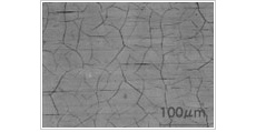Microscopic image of hard chrome plating showing cracks